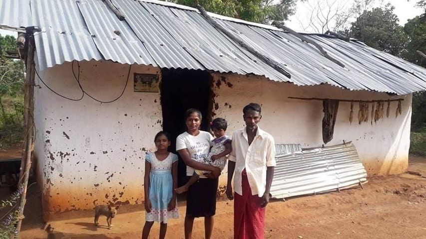 Poor family living in a tin roofed house